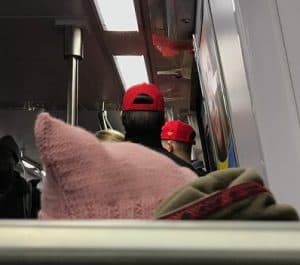 Pinky pussyhat vs. red Make American Great hat