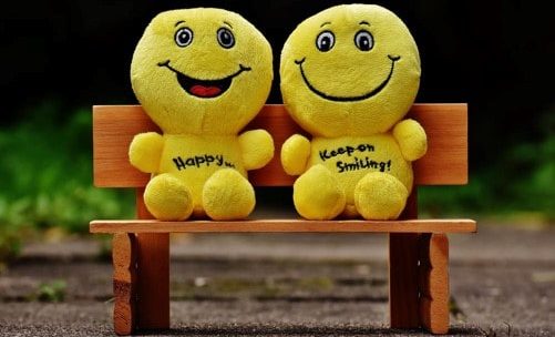 Image of two cartoonish puppets on a bench