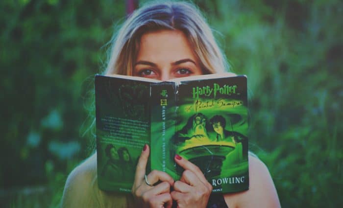 Photo of woman reading a Harry Potter book shows the power of storytelling.